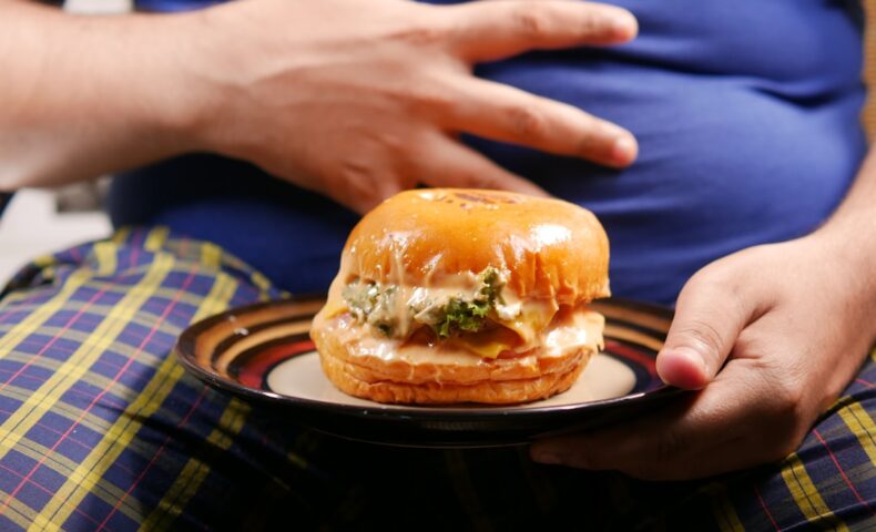 a person holding a plate with a sandwich on it