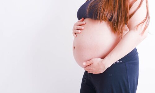 pregnant holding her tummy