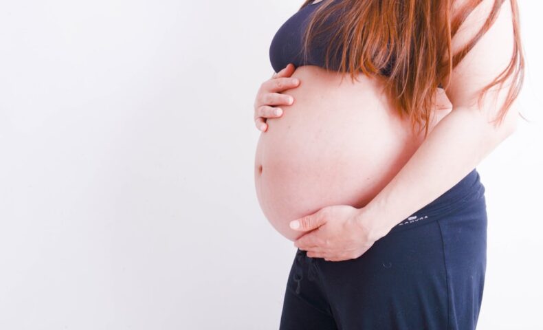 pregnant holding her tummy